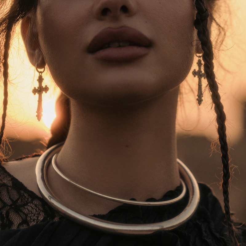 Thick rigid 925 sterling silver torque, a smooth open circular neck ring with a narrow gap at the front, no clasp. 