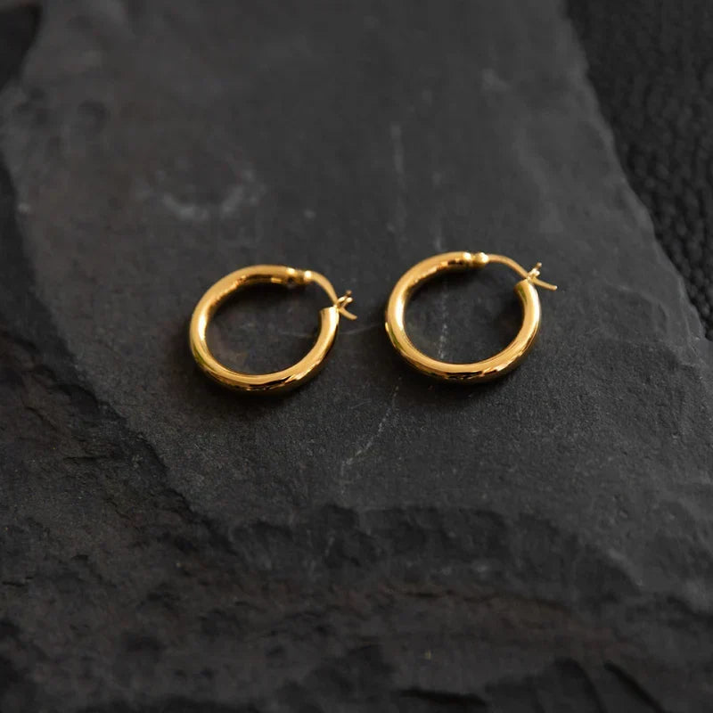 22K gold plated hoop earrings on a 925 sterling silver base, 25 mm diameter and 4 mm width, showing medium-hoop scale and structural profile.
