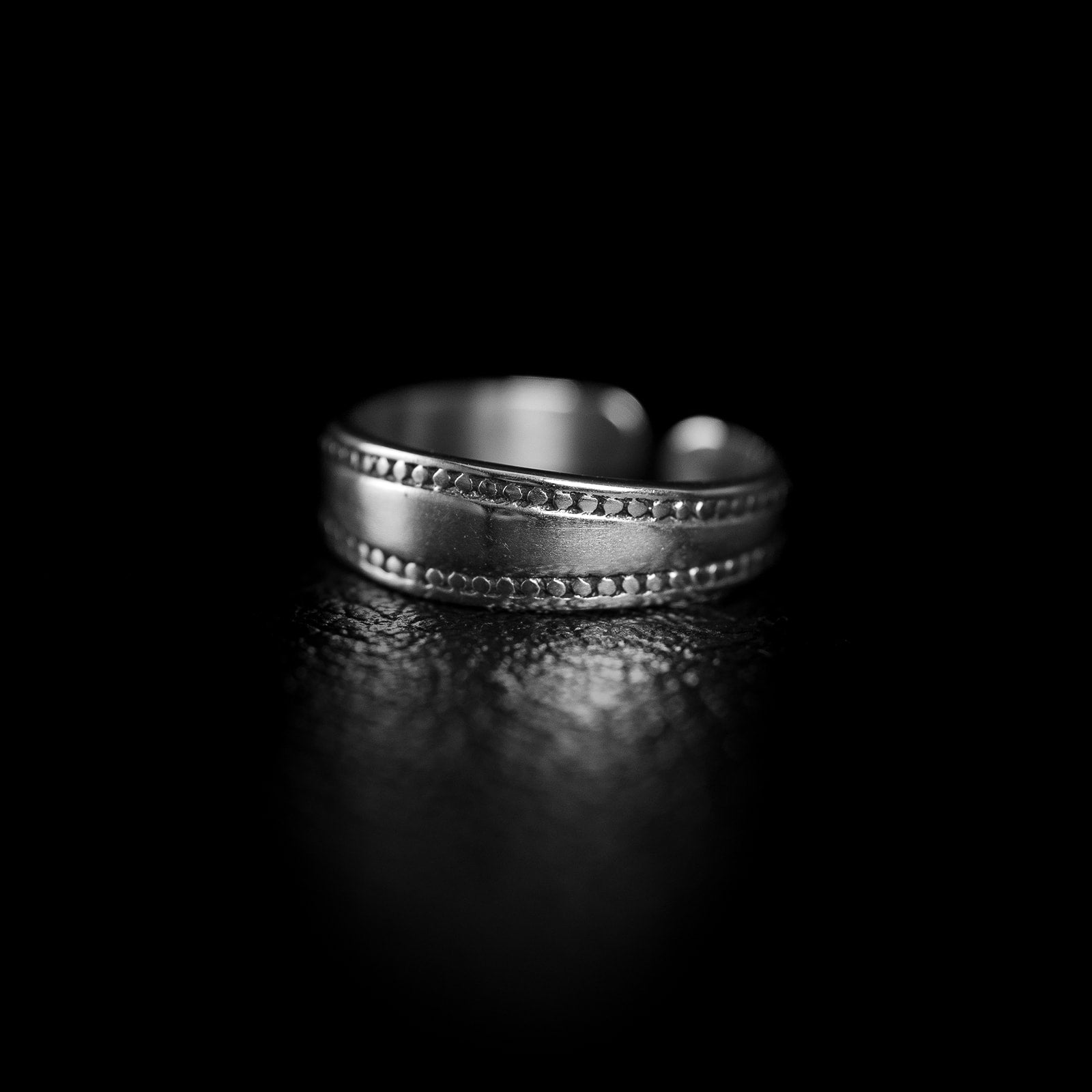 Wide 925 sterling silver toe ring with a matte curved band, fine beaded borders on each edge, open at the back.